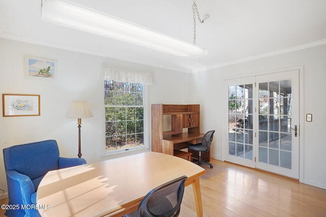 home office with light wood-style floors and ornamental molding