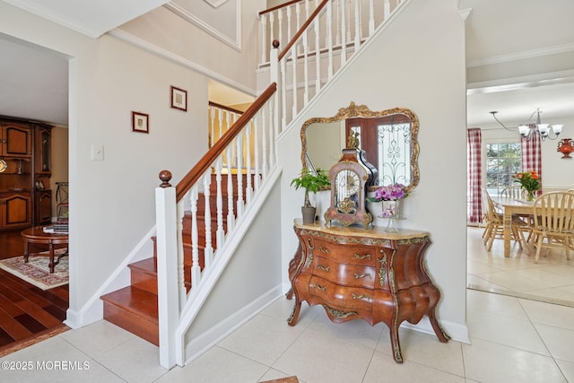 stairs featuring tile patterned flooring, crown molding, and baseboards