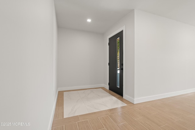 corridor with recessed lighting, light wood-style flooring, and baseboards