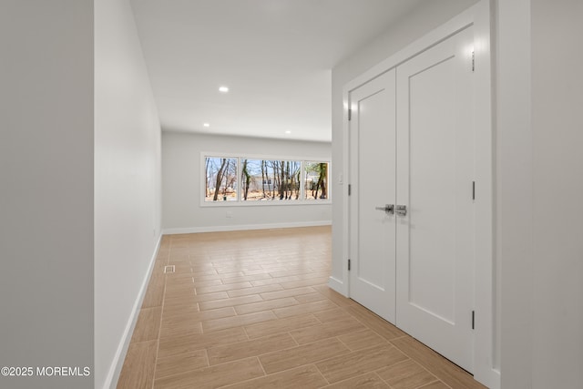 hallway with recessed lighting, baseboards, and wood finish floors