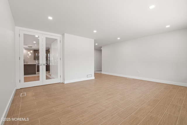 spare room featuring visible vents, recessed lighting, light wood-style flooring, and baseboards