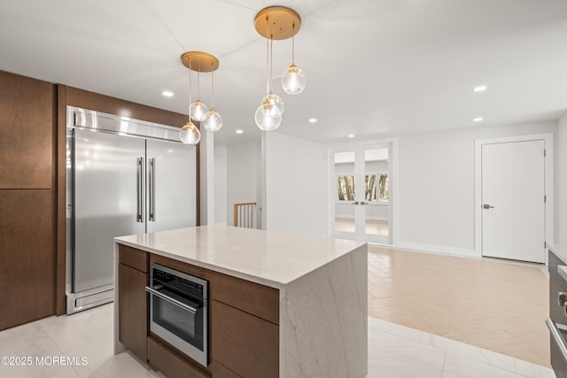 kitchen featuring a kitchen island, recessed lighting, and stainless steel appliances