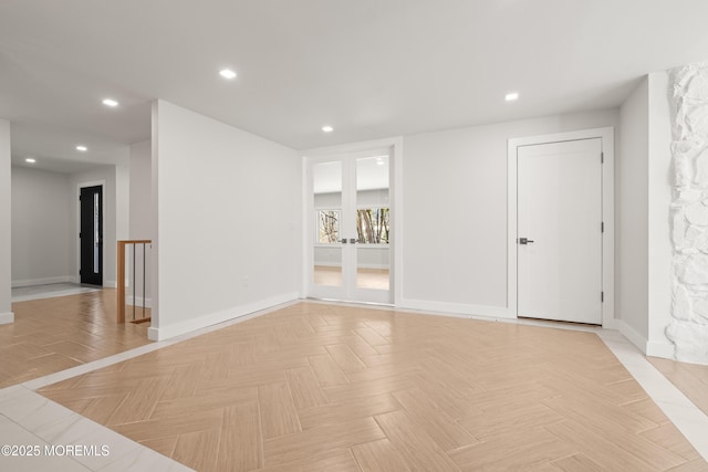 spare room featuring recessed lighting and baseboards