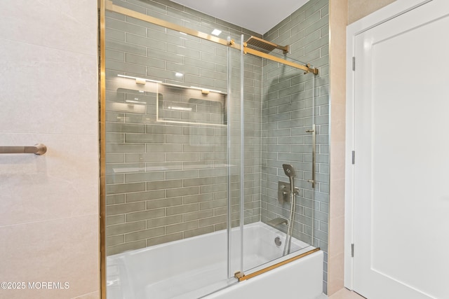 bathroom featuring shower / bath combination with glass door