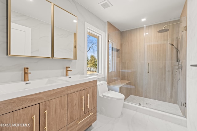 bathroom featuring visible vents, a stall shower, toilet, and a sink