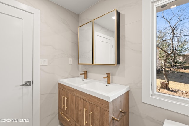 bathroom featuring double vanity, tile walls, and a sink