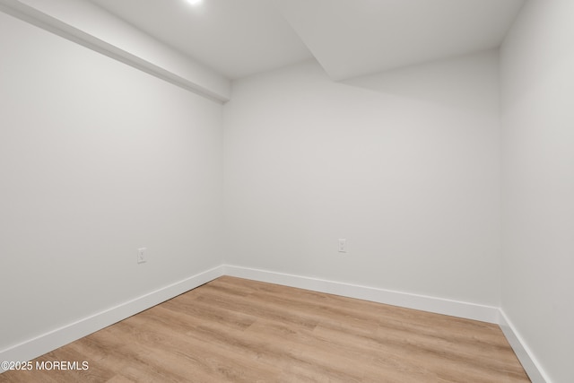 spare room with light wood finished floors and baseboards