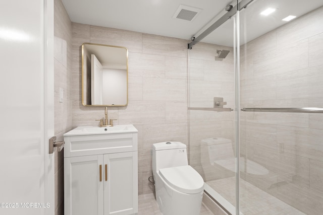 full bath with visible vents, toilet, tile walls, and a shower stall