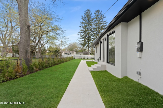 view of yard featuring fence and entry steps