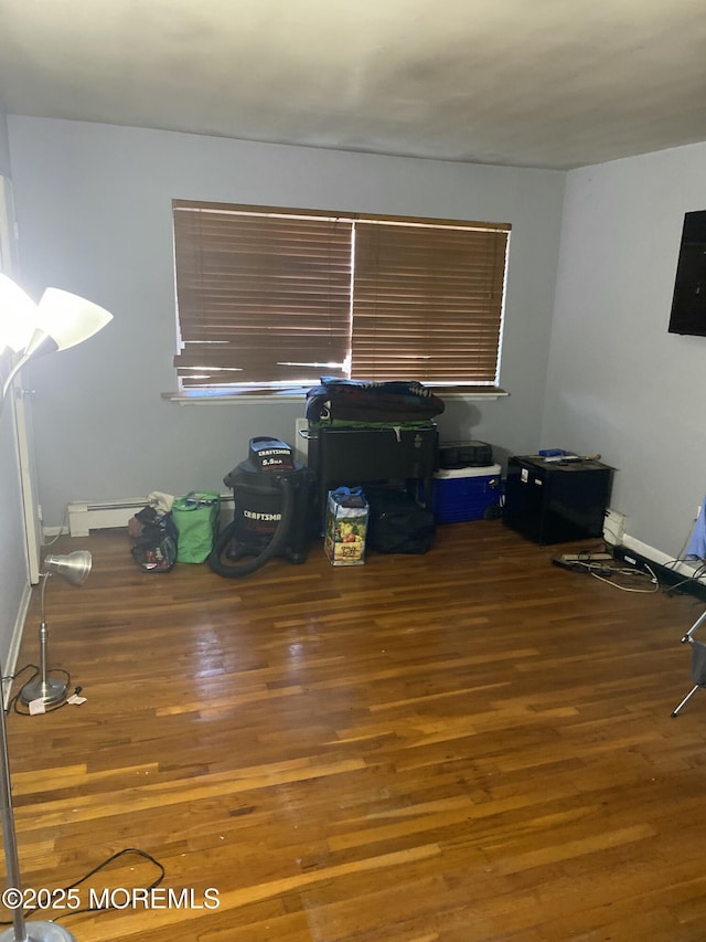 interior space with a baseboard radiator and wood finished floors