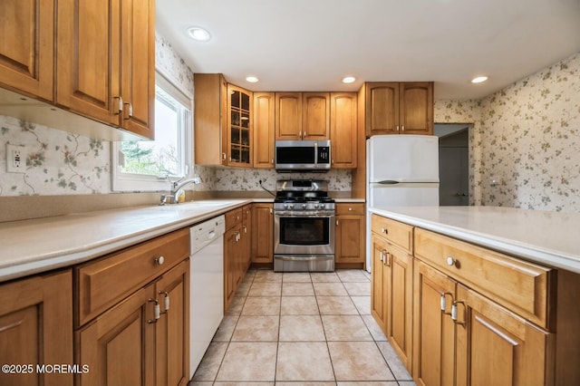 kitchen featuring a sink, tasteful backsplash, brown cabinets, and stainless steel appliances