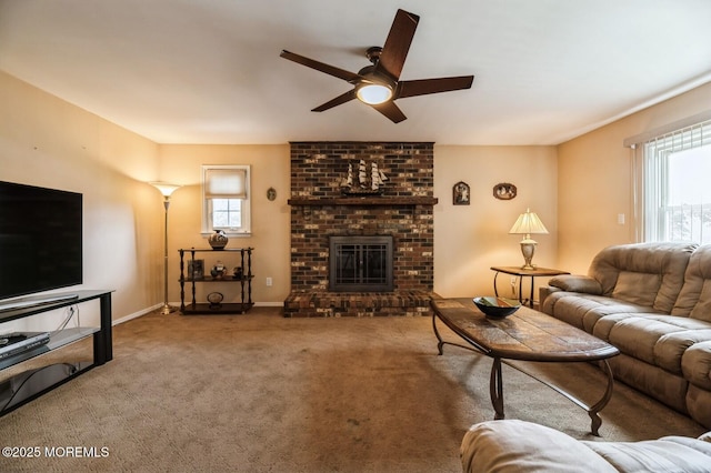 carpeted living area featuring baseboards, a brick fireplace, and ceiling fan