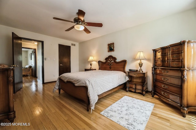 bedroom with baseboards, a ceiling fan, light wood finished floors, and visible vents