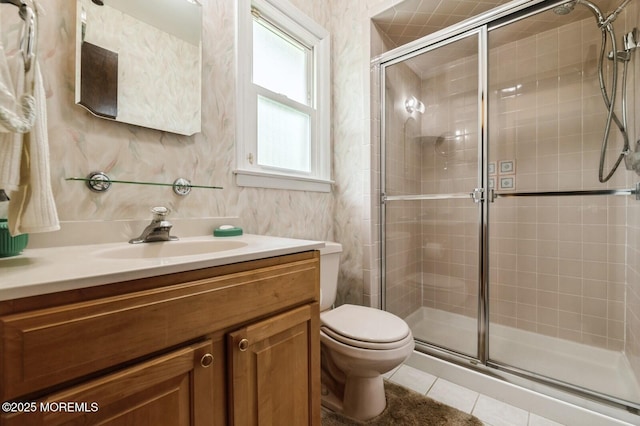 full bath featuring tile patterned flooring, a stall shower, toilet, and vanity