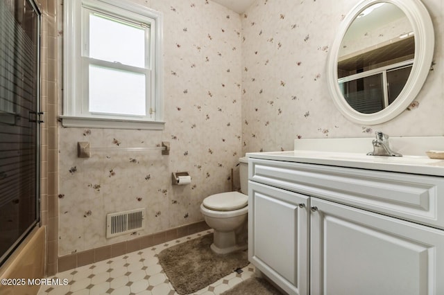 bathroom with visible vents, baseboards, toilet, and vanity