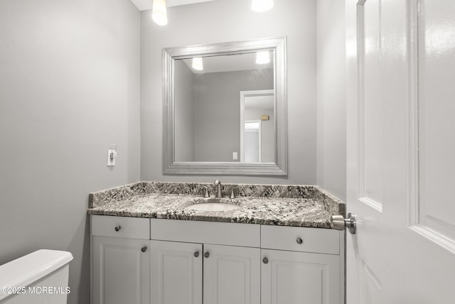 half bath with vanity and toilet