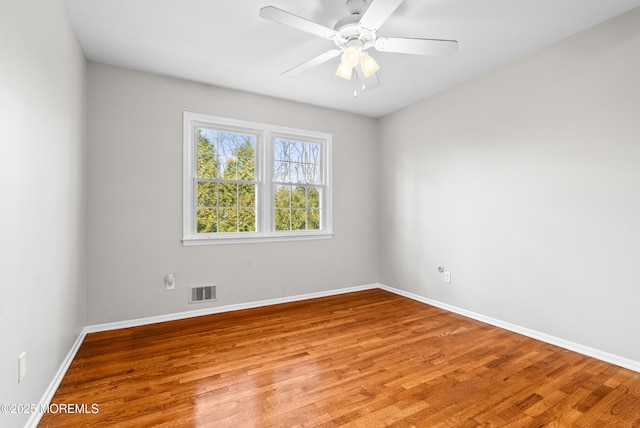 unfurnished room with baseboards and light wood finished floors