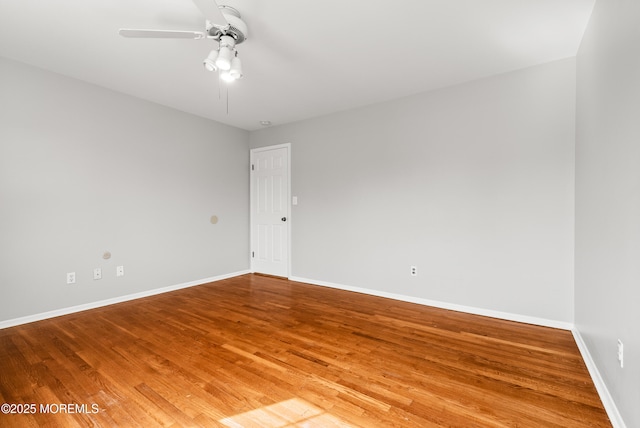 unfurnished room featuring wood finished floors, baseboards, and ceiling fan