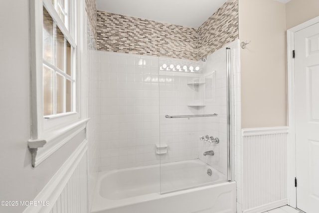 full bathroom with wainscoting and bathing tub / shower combination