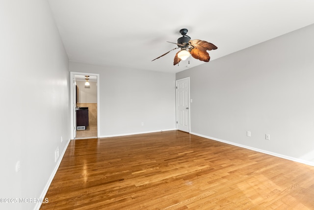 empty room with baseboards, light wood-type flooring, and ceiling fan