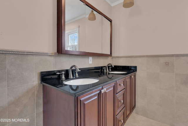 full bathroom featuring a sink, tile walls, double vanity, and tile patterned flooring