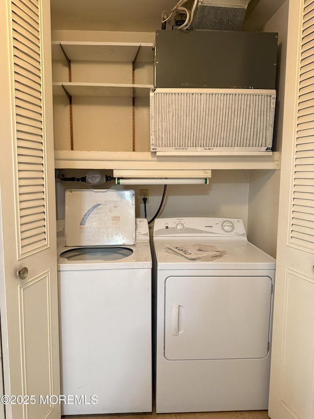 clothes washing area featuring laundry area and washing machine and dryer