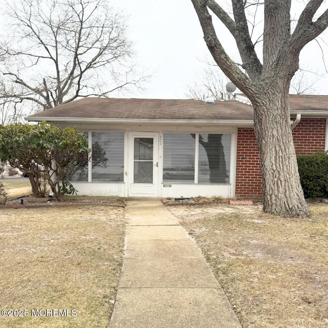 single story home featuring brick siding