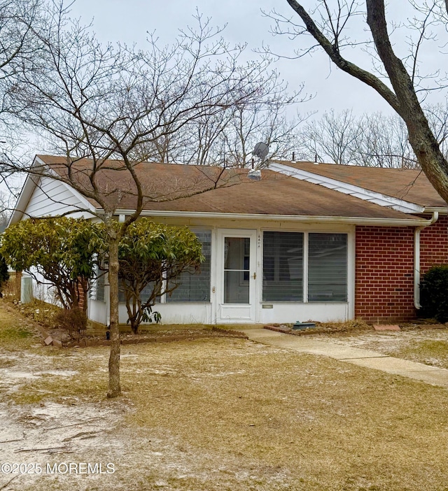 back of house featuring brick siding