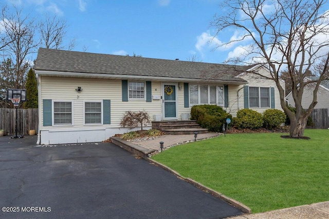 single story home with a front lawn, fence, and roof with shingles