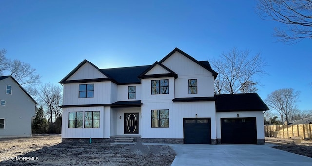 modern farmhouse style home with concrete driveway, fence, and a garage