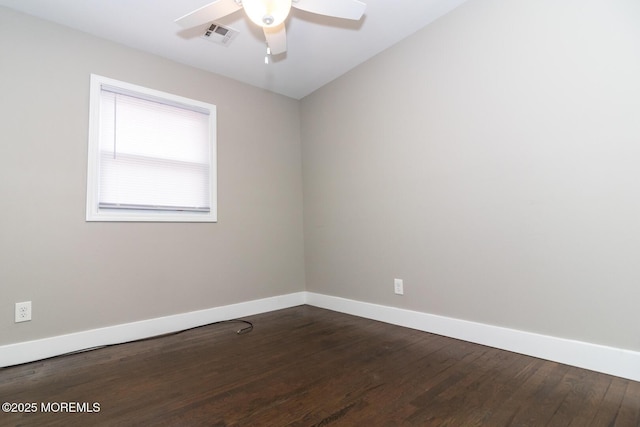 unfurnished room with visible vents, baseboards, ceiling fan, and dark wood-style flooring