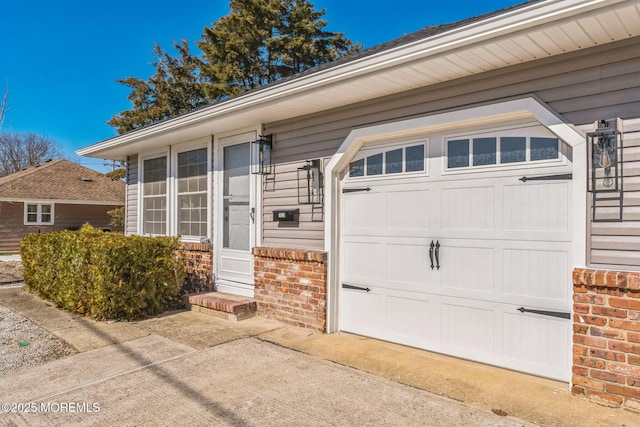 garage featuring concrete driveway
