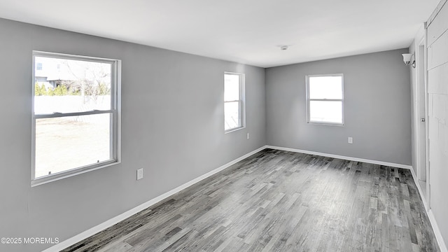 unfurnished bedroom featuring wood finished floors and baseboards