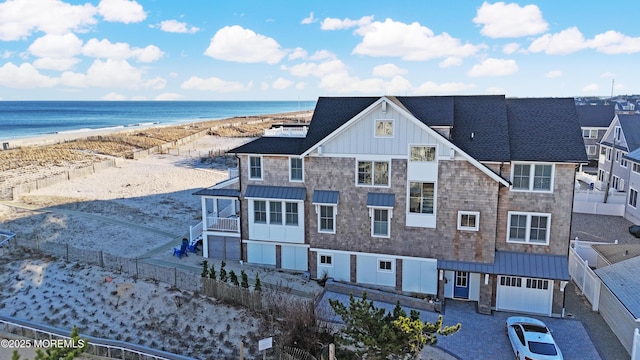 birds eye view of property featuring a water view and a view of the beach