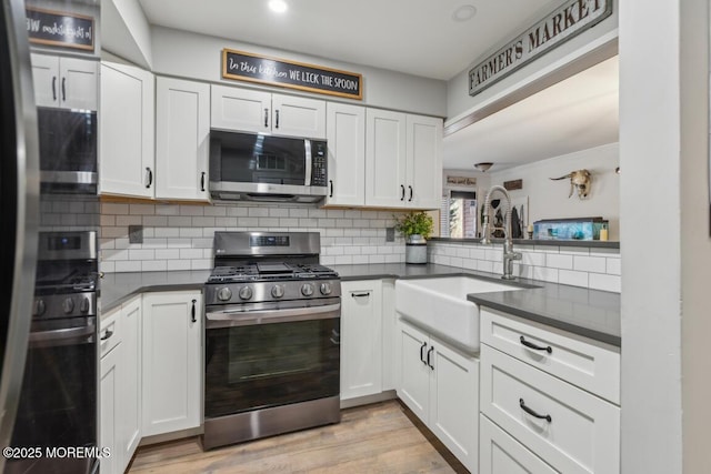 144 Brandywine Ct Unit 332, Brick, NJ 08724 - kitchen featuring dark countertops, stainless steel appliances, tasteful backsplash, and a sink