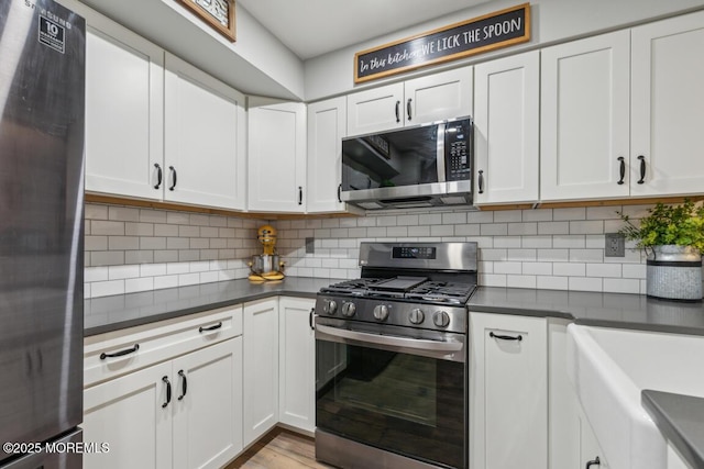 144 Brandywine Ct Unit 332, Brick, NJ 08724 - kitchen featuring decorative backsplash, dark countertops, white cabinets, and stainless steel appliances