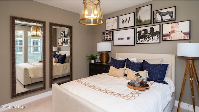 bedroom with carpet and an inviting chandelier