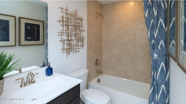 bathroom featuring shower / bathtub combination with curtain, toilet, and vanity