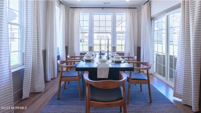 dining room with wood finished floors and visible vents