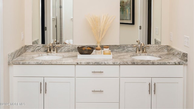 full bathroom featuring a sink and double vanity