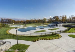 view of swimming pool featuring fence