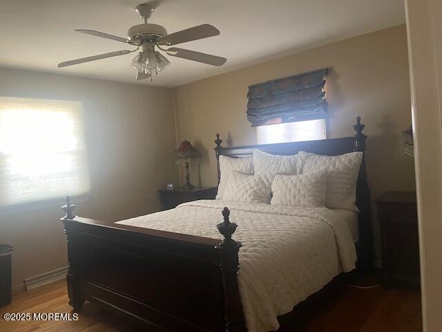 bedroom featuring wood finished floors and a ceiling fan