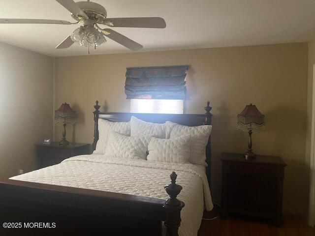 bedroom with wood finished floors and a ceiling fan