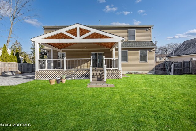 back of house featuring a lawn, a patio, and a fenced backyard