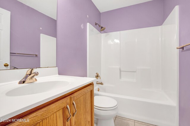 bathroom with vanity, toilet,  shower combination, and tile patterned flooring