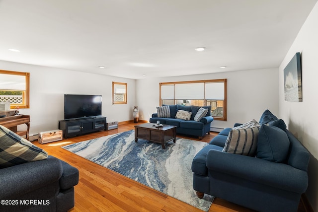 living room featuring recessed lighting, a baseboard heating unit, baseboards, and wood finished floors