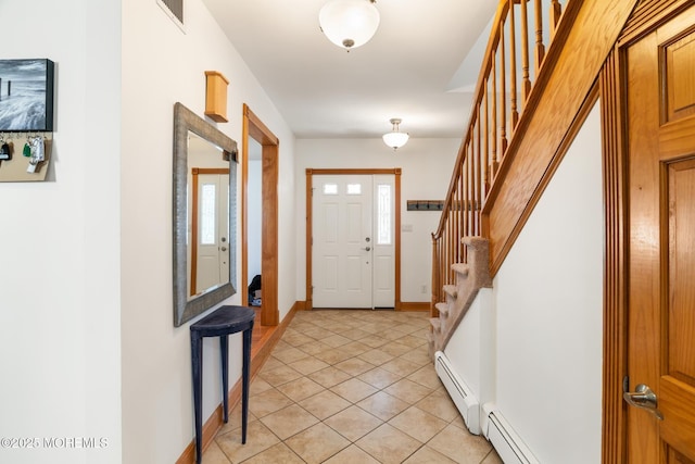 foyer entrance featuring stairs, light tile patterned floors, baseboards, and a baseboard radiator