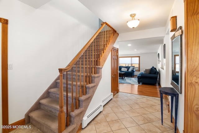 stairs featuring tile patterned floors, recessed lighting, baseboards, and a baseboard radiator