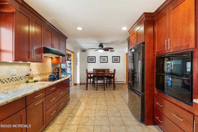 kitchen with light stone countertops, a ceiling fan, decorative backsplash, black appliances, and under cabinet range hood