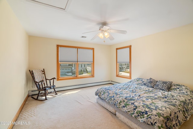 bedroom with baseboard heating, visible vents, baseboards, and carpet